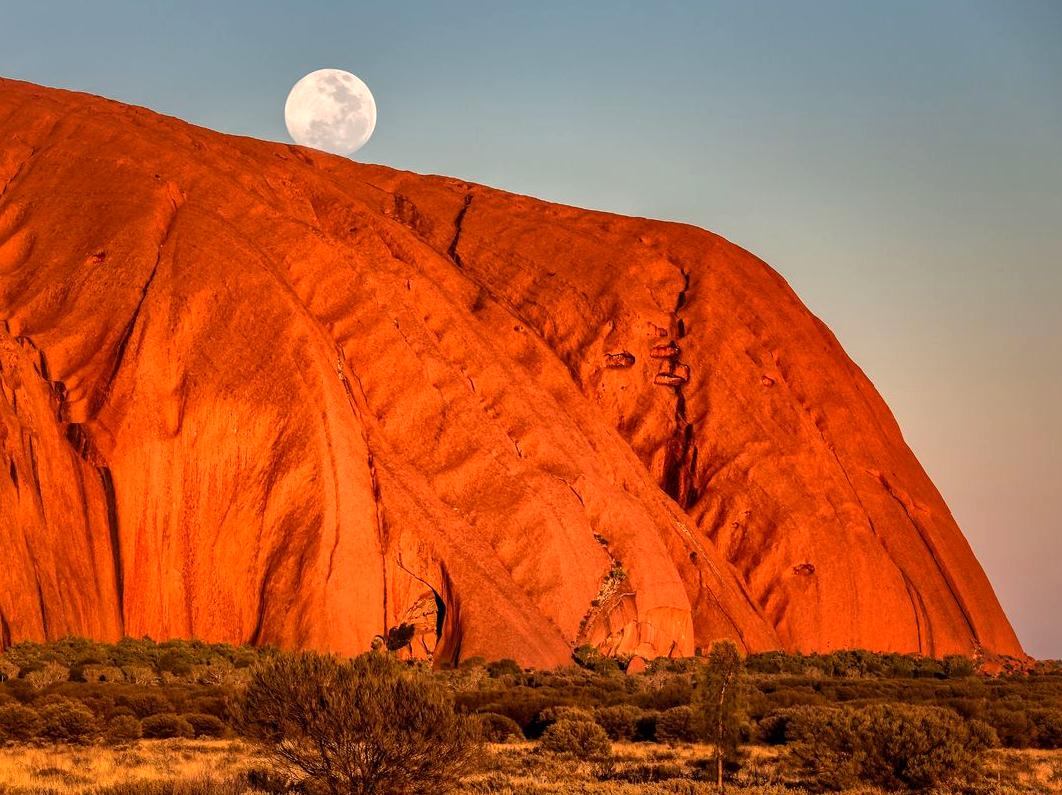 Enjoying Yoga at Dawn with Uluru as a Backdrop