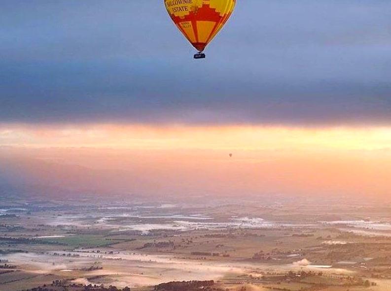 Witnessing the Dawn from a Balloon Over Desert Landscapes