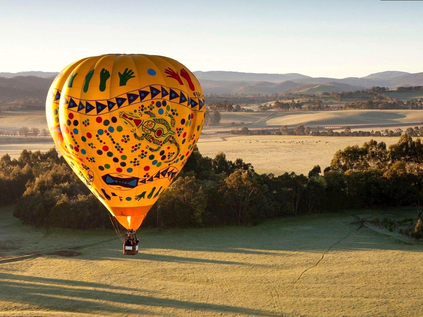 Soaring in a Balloon During Sunrise Over the Desert